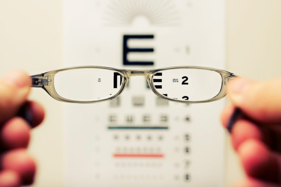 Woman giving residents of Jacksonville eye glasses 